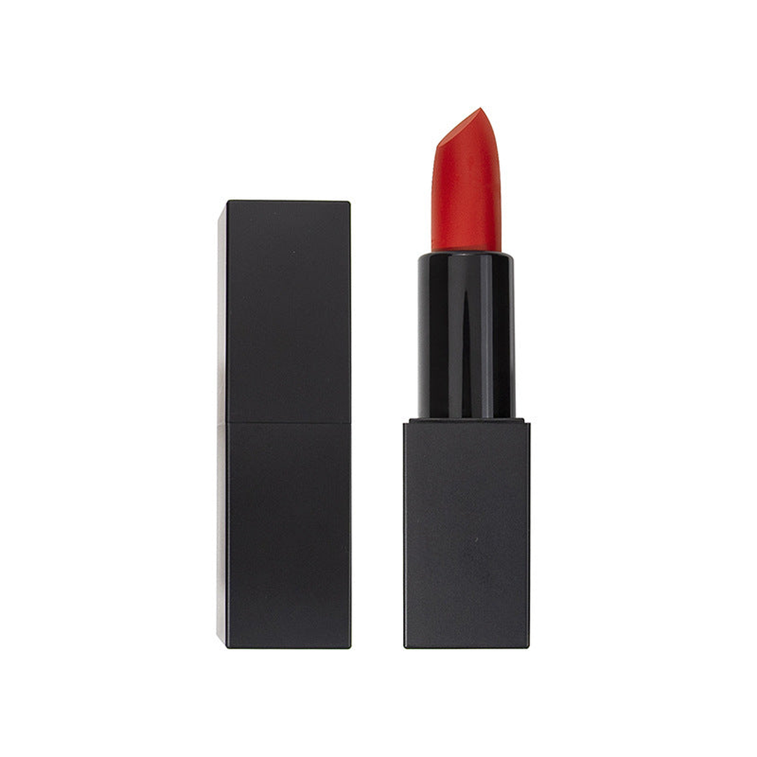 Bright red lipstick in a sleek black rectangular tube with cap off on white background